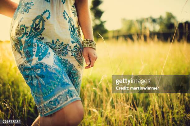 women in the sunny evening sky in the nature - martinwimmer stock pictures, royalty-free photos & images