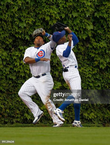 Marlon Byrd and teammate Alfonso Soriano of the Chicago Cubs avoid a collision in the outfield as Soriano makes the catch against the Florida Marlins...