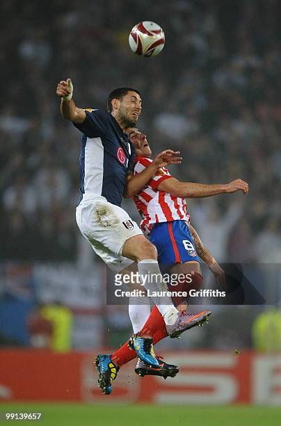 Clint Dempsey of Fulham and Raul Garcia of Atletico Madrid jump for a header during the UEFA Europa League final match between Atletico Madrid and...