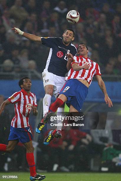 Clint Dempsey of Fulham and Raul Garcia of Atletico Madrid jump for a header during the UEFA Europa League final match between Atletico Madrid and...