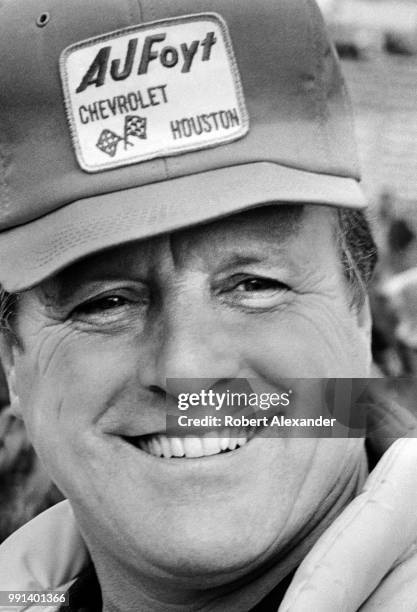 Racecar driver A.J. Foyt talks with friends in the garage at Daytona International Speedway in Daytona Beach, Florida, prior to the running of the...
