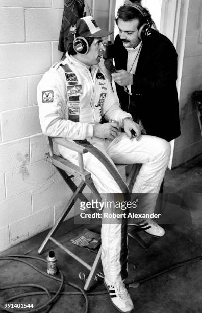 Prior to the start of the 1982 Daytona 500 auto race, NASCAR driver Darrell Waltrip is interviewed by MRN radio reporter Dr. Jerry Punch in the...