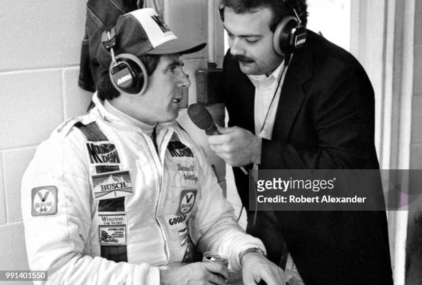 Prior to the start of the 1982 Daytona 500 auto race, NASCAR driver Darrell Waltrip is interviewed by MRN radio reporter Dr. Jerry Punch in the...