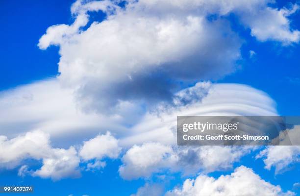 lenticular clouds forming from cumulus clouds - gaucín fotografías e imágenes de stock