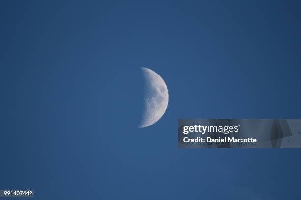 half moon in blue sky - blue moon imagens e fotografias de stock