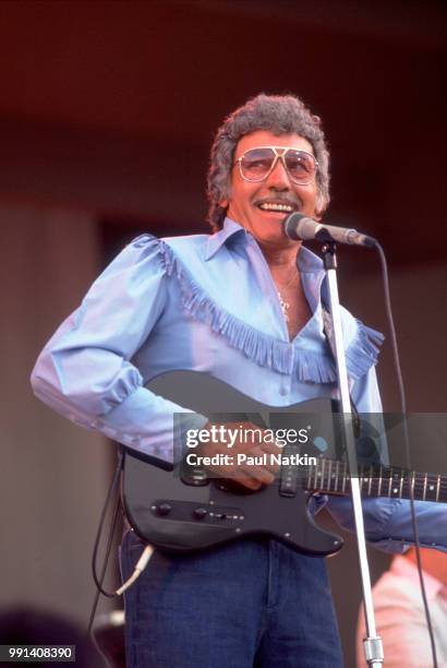 American singer Carl Perkins performs on stage at the Petrillo Bandshell in Chicago, Illinois, June 7, 1987.