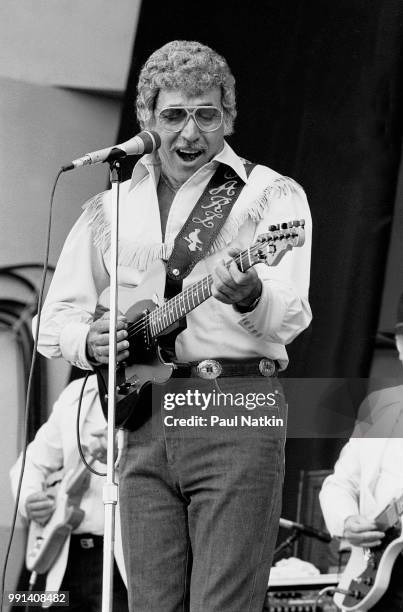 American singer Carl Perkins performs on stage at the Petrillo Bandshell in Chicago, Illinois, June 7, 1987.