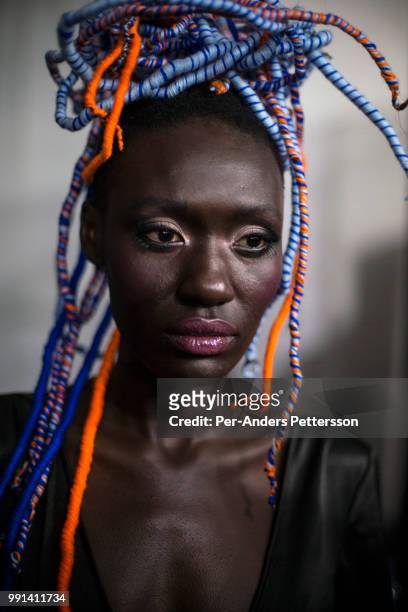 South Sudanese model Anyon Asola waits backstage before a show on August 19, 2017 in Mall of Africa north of Johannesburg, South Africa. African...