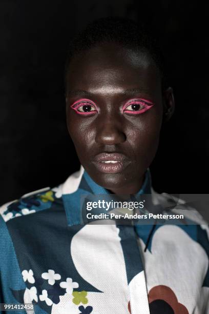 South Sudanese model Anyon Asola waits backstage before a show with the South African designers KLuk CGDT on August 16, 2017 in Mall of Africa north...