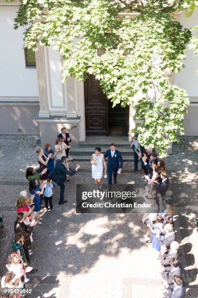 May26, 2018: A bridal couple comes out of the registry office after the wedding and walks through a trellis of wedding guests. The bride wears a...