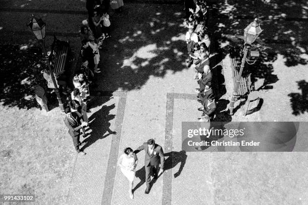 May26, 2018: A bridal couple comes out of the registry office after the wedding and walks through a trellis of wedding guests. The bride wears a...