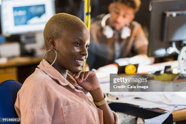 smiling creative businesswoman working in office - vanguardians stock pictures, royalty-free photos & images