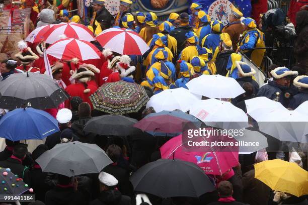 Fools standing under umbrellas at the Marktplatz in Dusseldorf, Germany, 11 November 2017. Carnival-goers celebrated the awakening of the traditional...