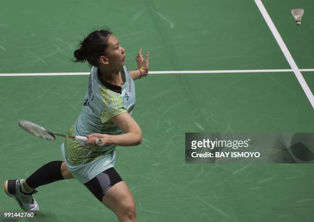 Pornpawee Chochuwong of Thailand hits a return against Sindhu Pusarla of India during their women's singles badminton match at the Indonesia Open in...
