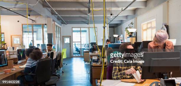 creative business people working in open plan office - vanguardians stock pictures, royalty-free photos & images