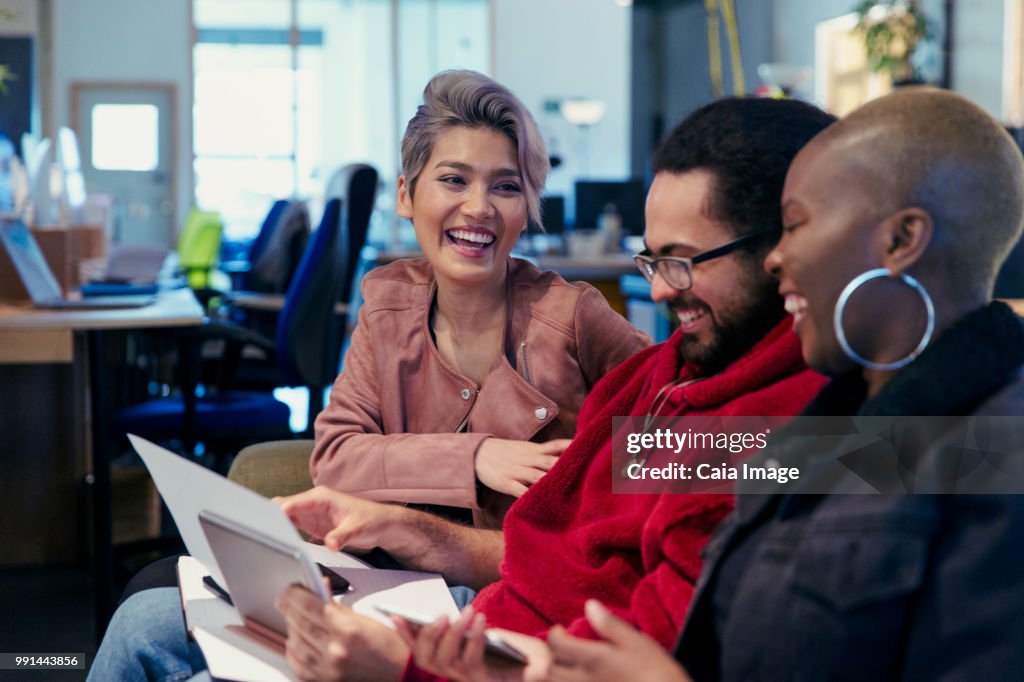 Laughing creative business people working in office