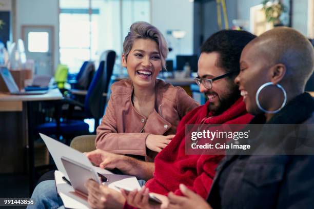 laughing creative business people working in office - crowdsourcing imagens e fotografias de stock