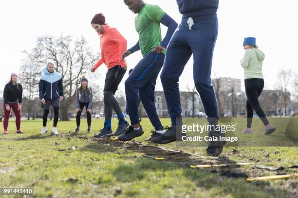 people exercising in park - agility ladder ストックフォトと画像