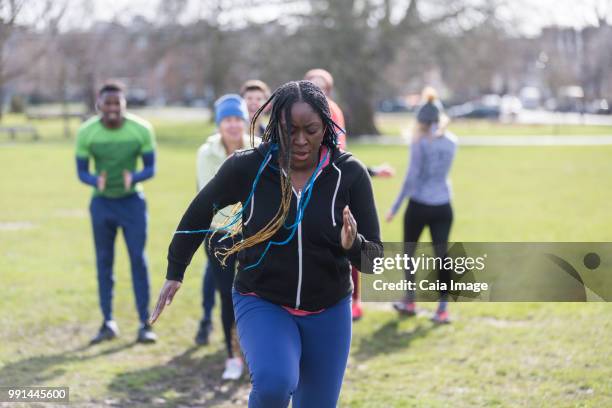 focused woman doing speed ladder drill in park - agility ladder stock pictures, royalty-free photos & images