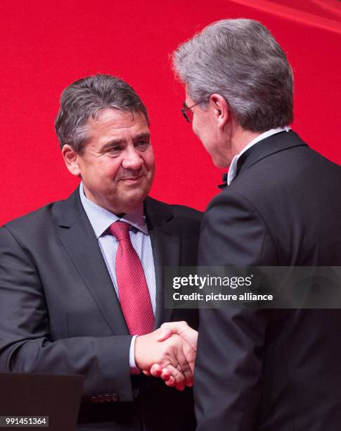German Minister of Foreign Affairs Sigmar Gabriel shakes hands with Siemens chairman Joe Kaeser during the ceremony for the Award for Understanding...