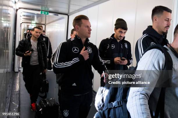 Germany's Sandro Wagner , Mats Hummels, goalkeeper Marc-Andre ter Stegen and their team mates board the Lufthansa airplane for their departure at...