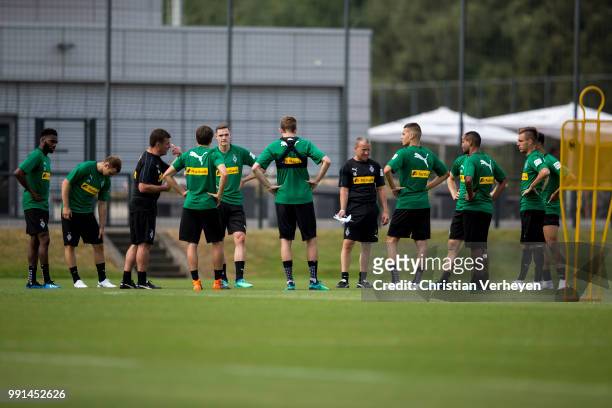 Head Coach Dieter Hecking talks to the Team during a training session of Borussia Moenchengladbach at Borussia-Park on July 04, 2018 in...