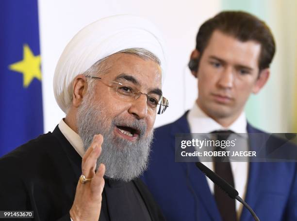 Austria's Chancellor Sebastian Kurz listens to Iranian President Hassan Rouhani during a joint press conference following a meeting on July 4, 2018...