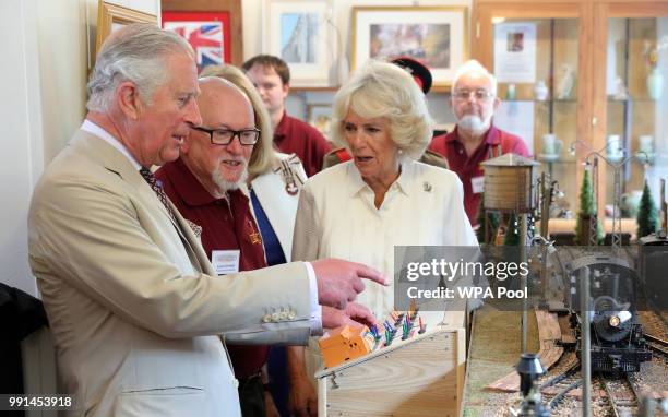 Prince Charles, Prince of Wales and Camilla, Duchess of Cornwall try out a model railway as they mark the 150th anniversary of the Heart of Wales...
