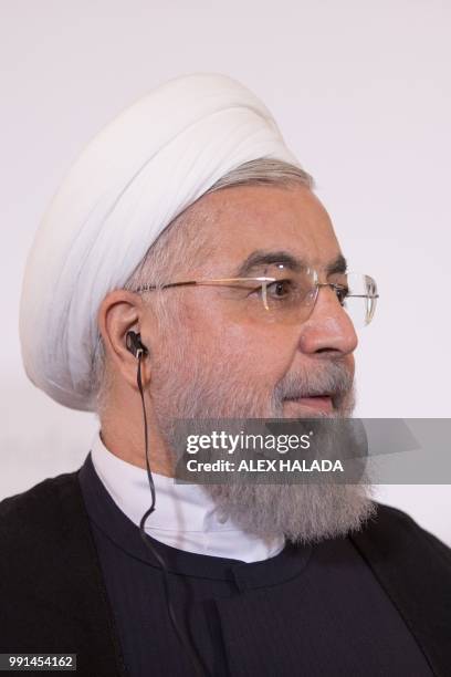 Iranian President Hassan Rouhani listens during a joint press conference with Austria's Chancellor following a meeting on July 4, 2018 at the...