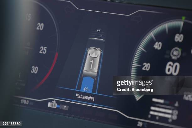 Dashboard operating system displays the distance between trucks inside a MAN SE TGX freight truck during a wireless communication technology...