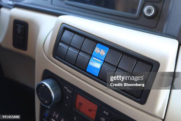 Operating switches sit on the dashboard of a MAN SE TGX freight truck during a wireless communication technology "platooning" test drive at Berlin...