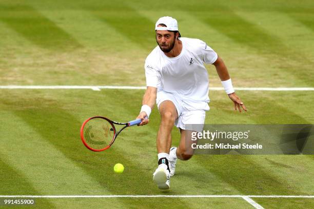 Paolo Lorenzi of Italy returns against Gael Monfils of France during their Men's Singles second round match on day three of the Wimbledon Lawn Tennis...