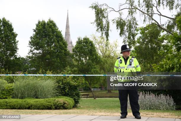 Police officer stands at a cordon outside Queen Elizabeth Gardens in Salisbury, southern England, on July 4, 2018 believed to be cordoned off in...