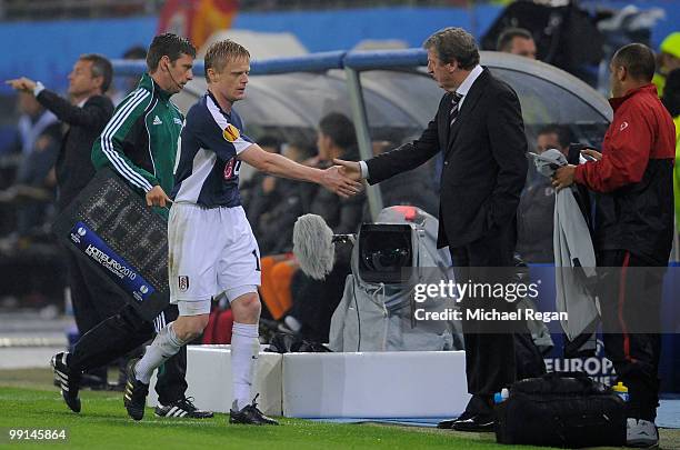 Damien Duff of Fulham shakes hands with head coach Roy Hodgson after being substituted during the UEFA Europa League final match between Atletico...