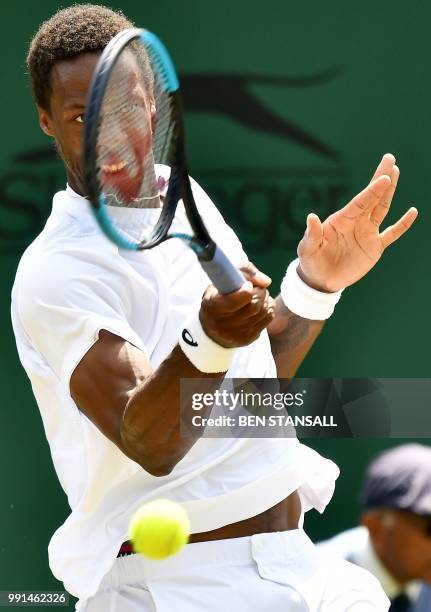 France's Gael Monfils returns against Italy's Paolo Lorenzi during their men's singles second round match on the third day of the 2018 Wimbledon...