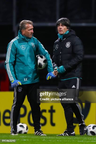 Germany national football team head coach Joachim Loew speaks with goalkeeping coach Andreas Koepke during a training session in Cologne, Germany, 12...