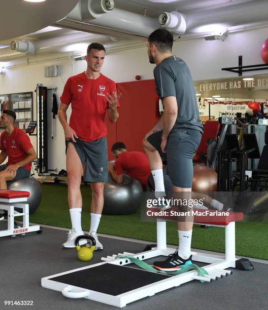 Rob Holding and Carl Jenkinson of Arsenal talk during a training session at London Colney on July 4, 2018 in St Albans, England.