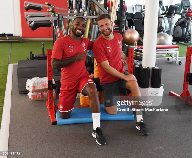 Alex Lacazette and Shkodran Mustafi of Arsenal smile during a training session at London Colney on July 4, 2018 in St Albans, England.