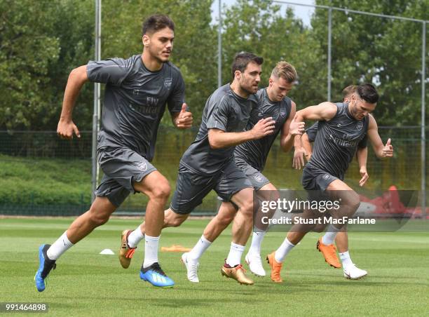 Konstantinos Mavropanos, Sokratis Papastathopolus, Rob Holding and Lucas Perez of Arsenal runs during a training session at London Colney on July 4,...