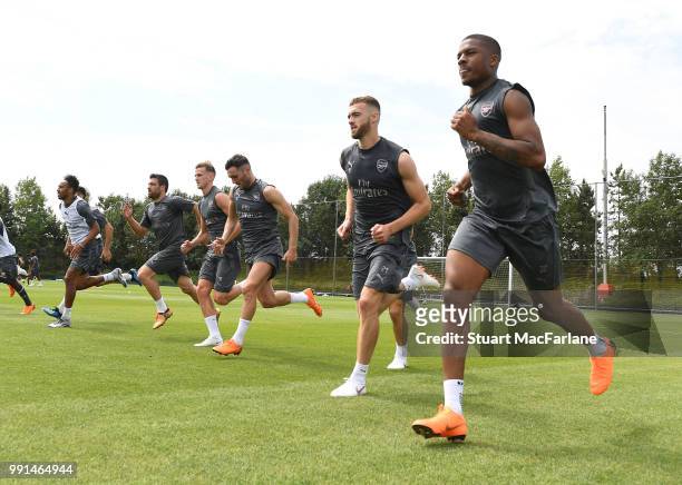 Calum Chambers and Chuba Akpom of Arsenal run during a training session at London Colney on July 4, 2018 in St Albans, England.