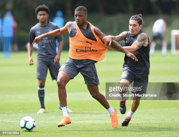 Chuba Akpom and Hector Bellerin of Arsenal fight for the ball during a training session at London Colney on July 4, 2018 in St Albans, England.