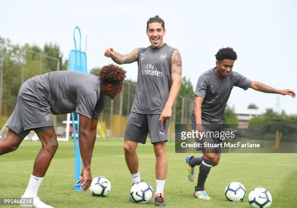 Jeff Reine-Adelaide, Hector Bellerin and Reiss Nelson of Arsenal gesture during a training session at London Colney on July 4, 2018 in St Albans,...