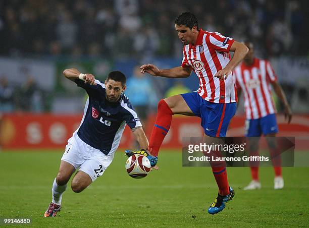 Clint Dempsey of Fulham challenges Raul Garcia of Atletico Madrid during the UEFA Europa League final match between Atletico Madrid and Fulham at HSH...