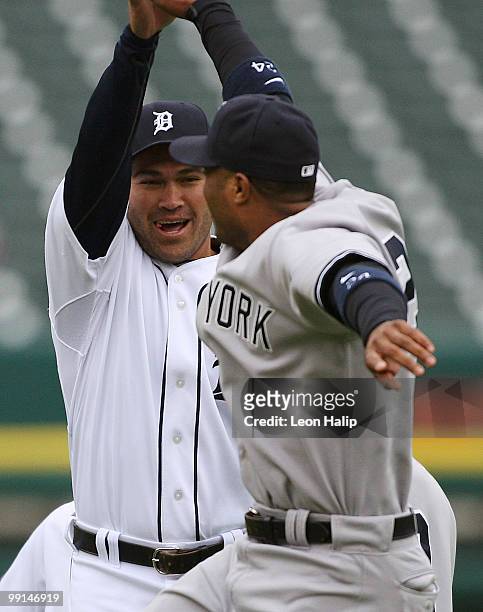 Johnny Damon of the Detroit Tigers and Robinson Cano of the New York Yankees greet each other in center field prior to the start of the game on May...