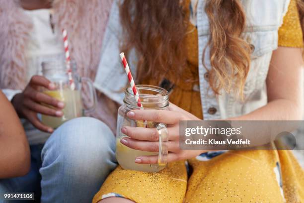 girls sitting on staircase & drinking lemonade - traditional lemonade stock pictures, royalty-free photos & images