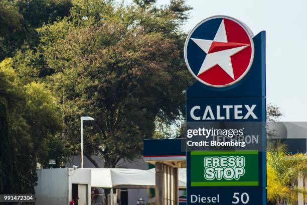 Sign displays a company logo and fuel prices at a Caltex gas station, operated by Chevron Corp., in Pretoria, South Africa, on Wednesday, July 4,...