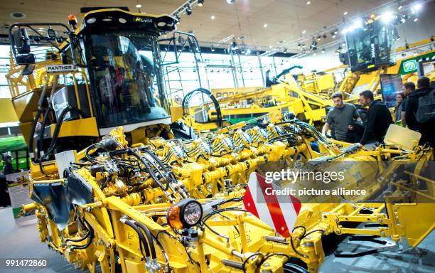 Visitors watching a harvesting machine at the stand of the Ropa company in the agricultural technology fair Agritechnica in the Hanover Convention...