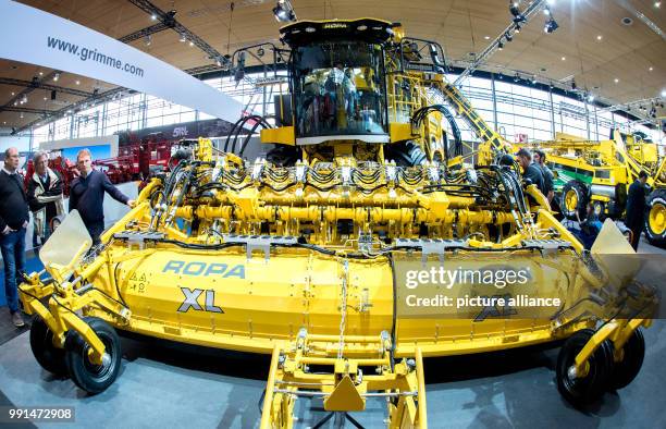 Visitors watching a harvesting machine at the stand of the Ropa company in the agricultural technology fair Agritechnica in the Hanover Convention...