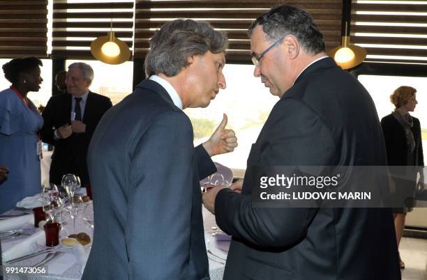 Decaux Chief Executive Officer Jean-Charles Decaux speaks with Total Chief Executive Officer Patrick Pouyanne during a lunch with businessmen in...