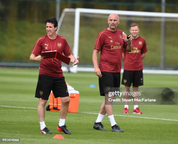 Arsenal Head Coach Unai Emery with assistant Steve Bould during a training session at London Colney on July 4, 2018 in St Albans, England.